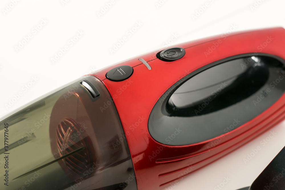 Close-up view of a red car vacuum cleaner
