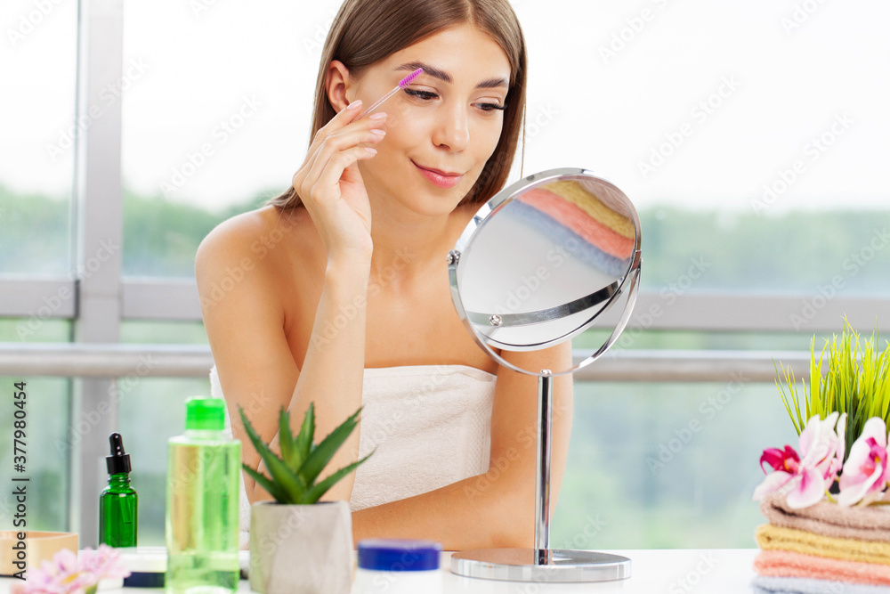 Pretty woman applies makeup in the bathroom of elite apartment Pretty woman applies makeup in the bathroom of elite apartment