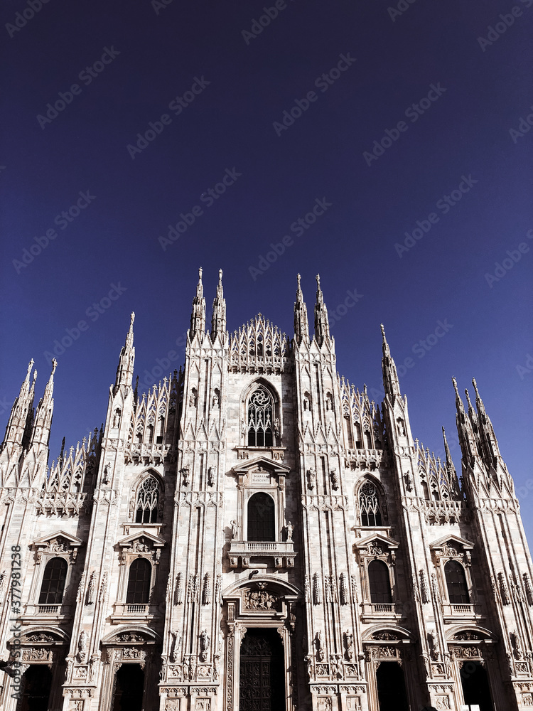 Milan Cathedral (Duomo di Milano) and monument to Victor Emmanuel II on the Piazza del Duomo in Milan, Italy. Milan Cathedral is the largest church in Italy and the main tourist attraction of Milan.