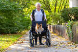 a cute dog is being driven around by an old lady in a wheelchair