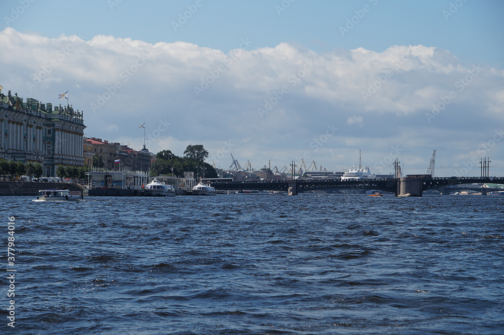 View from a boat to the coast in the city of St. Petersburg in Russia, you can see the bridge, port, pier and the Winter Palace, the residence of the Russian tsars