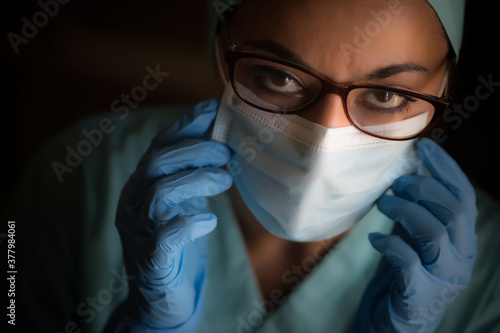Young female medic  wearing a mask and glasses