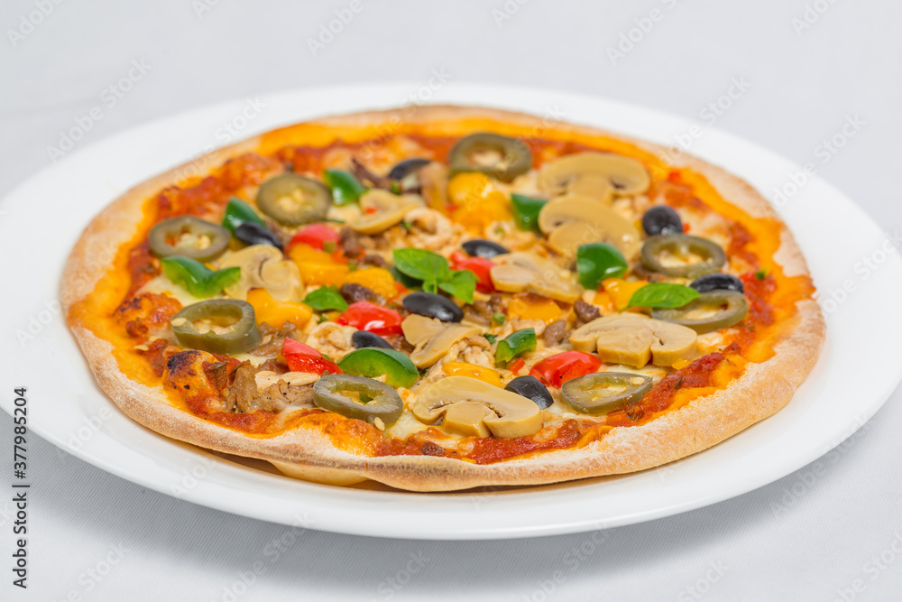 Closeup of Chicken mushroom jalapeno and red pepper pizza on white plate isolated on white background. Homemade Pizza.