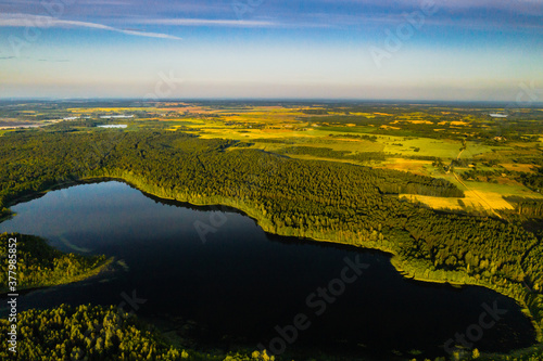 Top view of Bolta lake in the forest in the Braslav lakes National Park at dawn, the most beautiful places in Belarus.An island in the lake.Belarus. photo