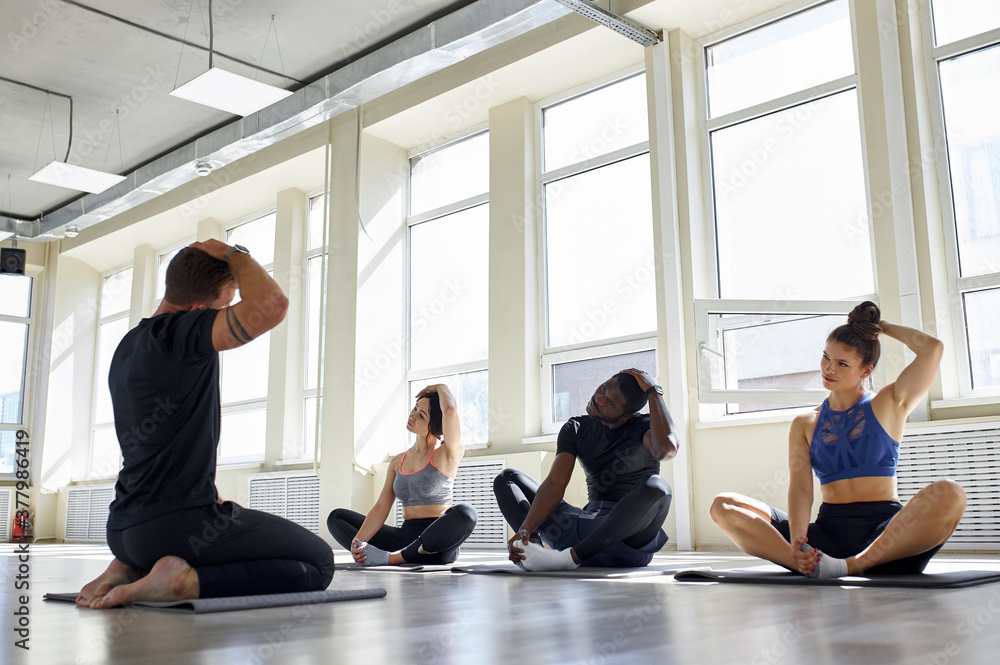 group of diverse poople practicing yoga isolated in room, young men and women meditate, do exercises, practice different yoga poses group of diverse poople practicing yoga isolated in room, young men and women meditate, do exercises, practice different yoga poses