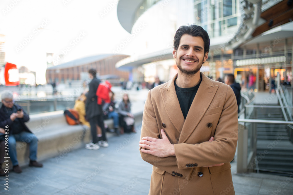 Handsome man walking outdoors in a crowded street Handsome man walking outdoors in a crowded street