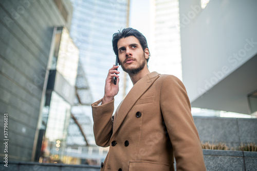 Man talking on the phone in a modern city