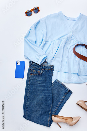 modern stylish blouse and jeans flat lay, elegant outfit with high heels are perfect for walks, party.