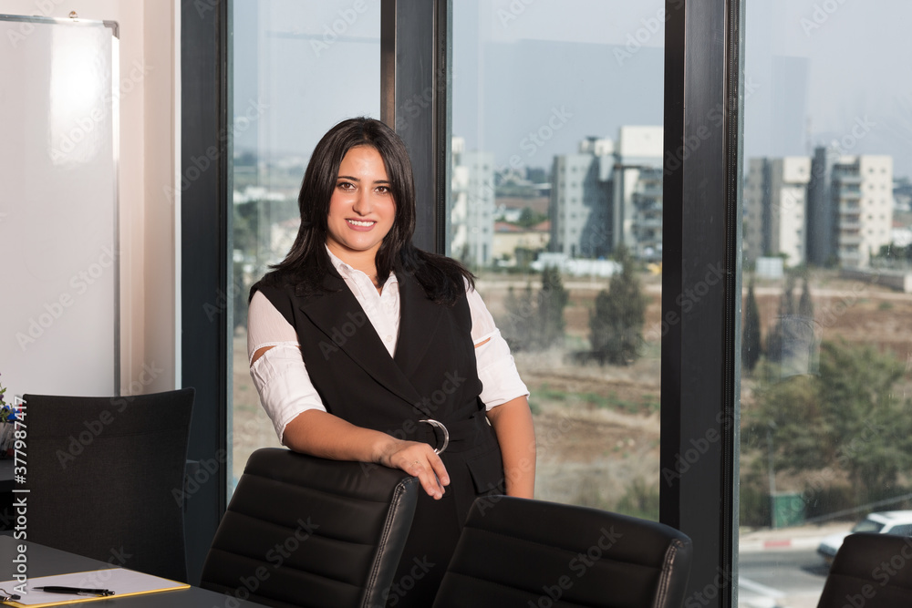 Portrait of beautiful young woman working in office looking and smiling at camera Portrait of beautiful young woman working in office looking and smiling at camera