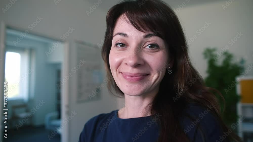 Cheerful girl smiles in the office. Motivation by good mood, woman's smile. An inner sense of job satisfaction. Cheerful girl smiles in the office. Motivation by good mood, woman's smile. An inner sense of job satisfaction.