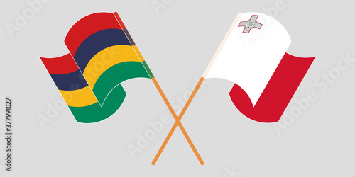 Crossed and waving flags of Mauritius and Malta