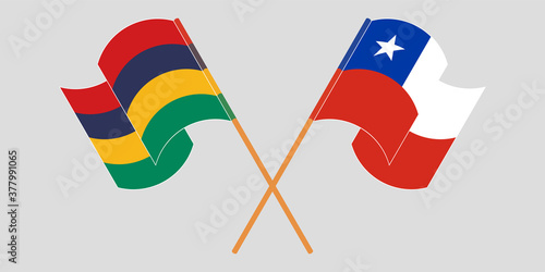 Crossed and waving flags of Mauritius and Chile