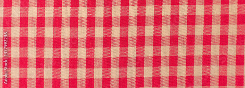 Close up of a red and white checkered tablecloth