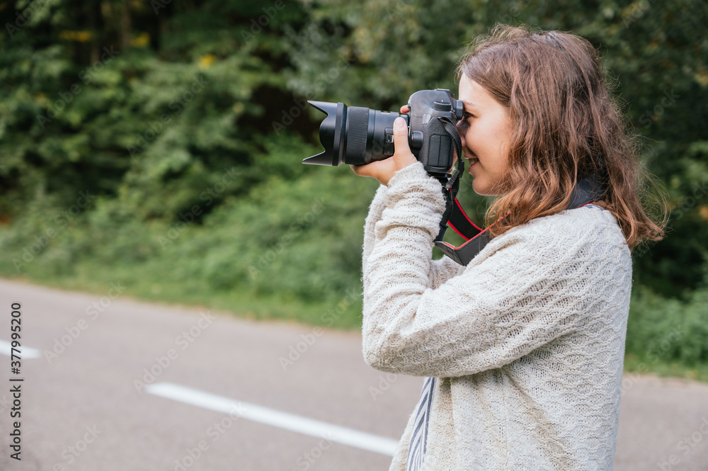Female photographer taking pictures outdoors Female photographer taking pictures outdoors