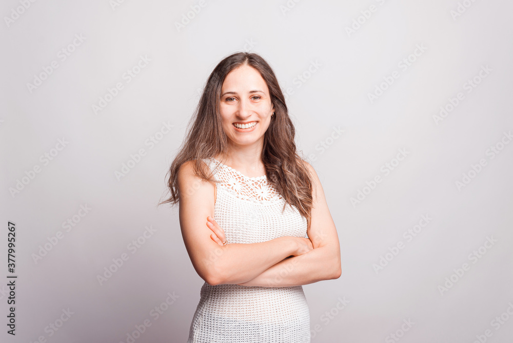 Portrait of young smiling woman with crossed arms looking confident at the camera Portrait of young smiling woman with crossed arms looking confident at the camera