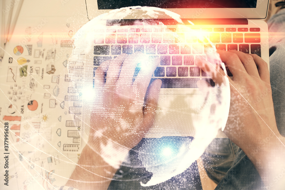 Double exposure of man's hands typing over computer keyboard and business theme hologram drawing. Top view. Financial markets concept. Double exposure of man's hands typing over computer keyboard and business theme hologram drawing. Top view. Financial markets concept.