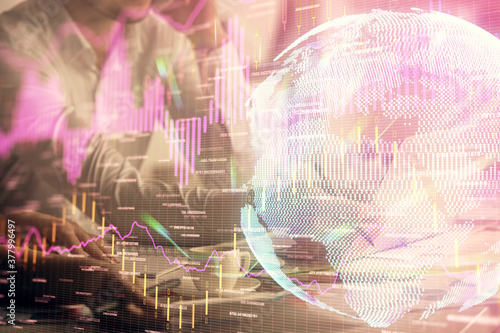 Multi exposure of man and woman working together and financial chart hologram. Business concept. Computer background. © peshkova