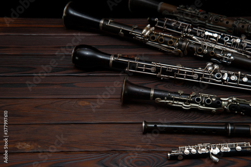 Obraz na płótnie Woodwind instruments lie on a wooden surface