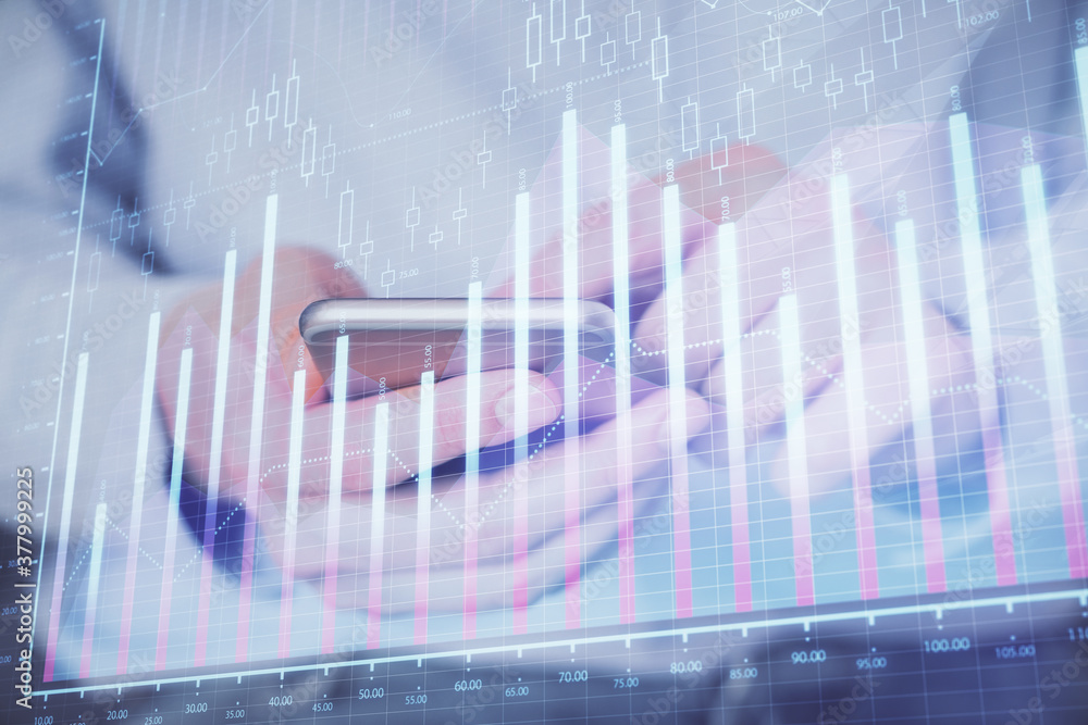 Double exposure of man's hands holding and using a digital device and forex graph drawing. Financial market concept. Double exposure of man's hands holding and using a digital device and forex graph drawing. Financial market concept.