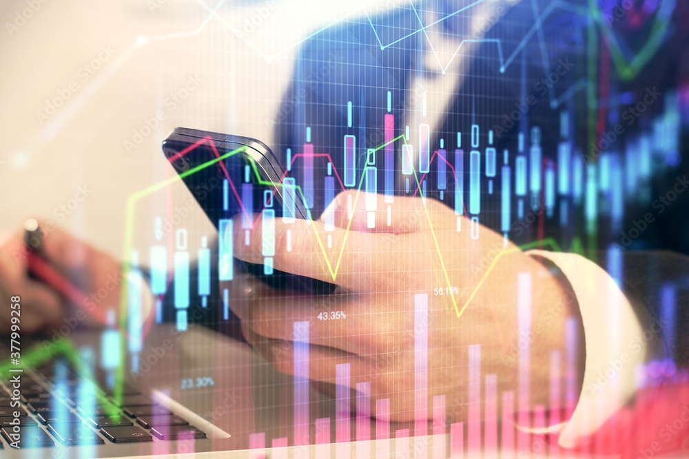 Multi exposure of man's hands holding and using a digital phone and forex graph drawing. Financial market concept. Multi exposure of man's hands holding and using a digital phone and forex graph drawing. Financial market concept.