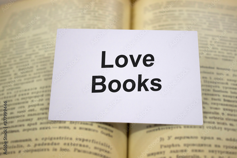 Love books written in white note on open books Love books written in white note on open books