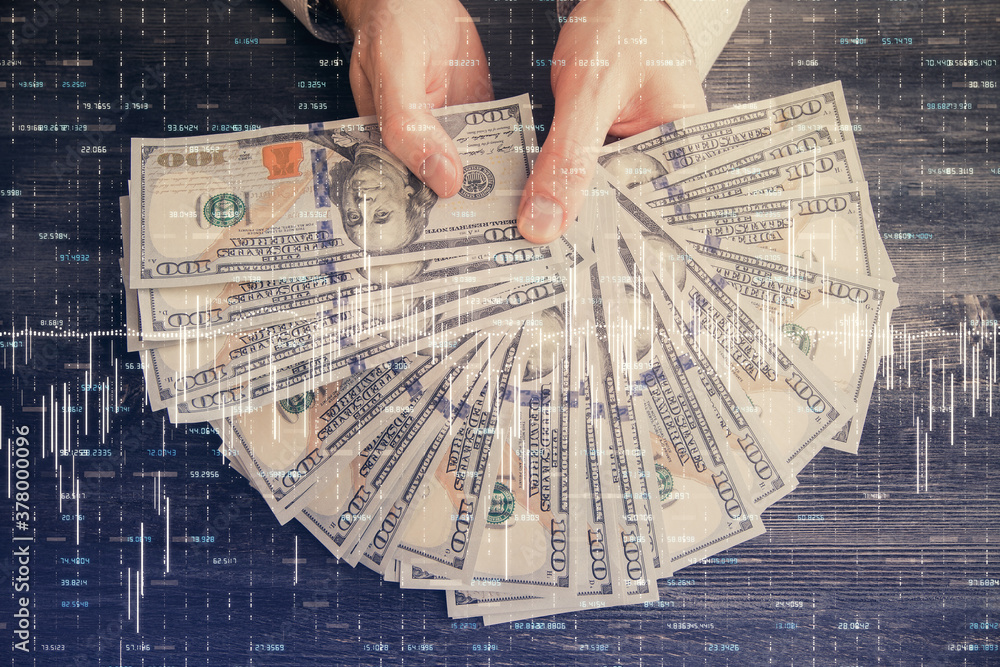 Multi exposure of financial graph drawing hologram and USA dollars bills and man hands. Analysis concept. Multi exposure of financial graph drawing hologram and USA dollars bills and man hands. Analysis concept.