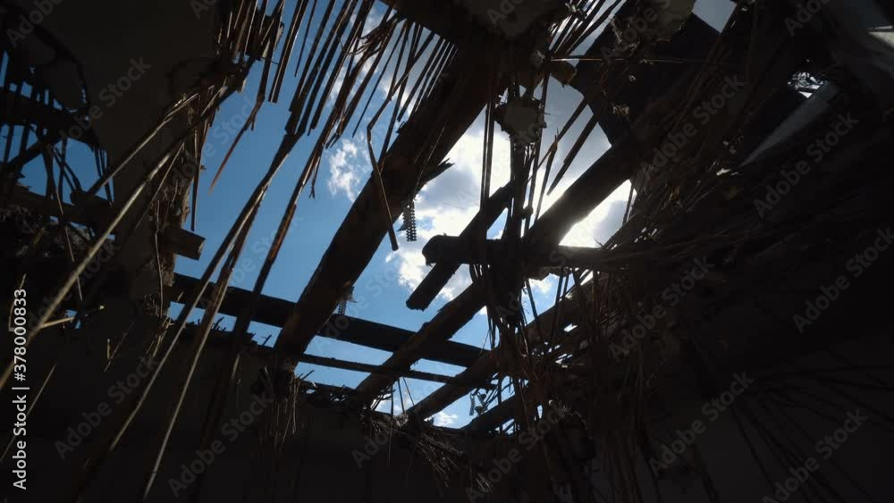 Burnt out house with charred roof trusses and burnt furniture Burnt out house with charred roof trusses and burnt furniture