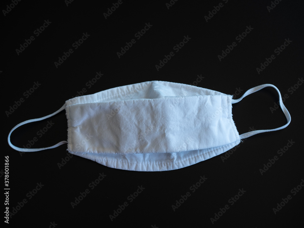 Mask made of cotton, corona virus protection isolated on a black background Mask made of cotton, corona virus protection isolated on a black background