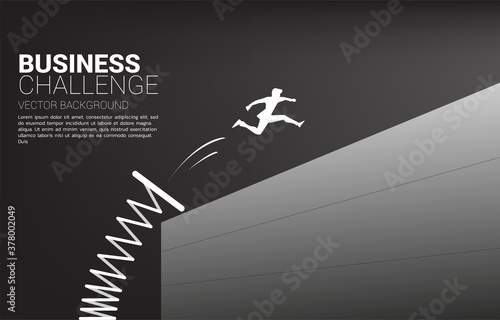 Silhouette of businessman jump across the wall with springboard. Concept of boost and move forward in business.