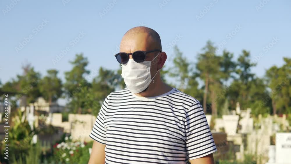 Woman with a protective face mask crying weeping and mourning on a cemetery in Turkey full of death
Woman with a protective face mask crying weeping and mourning on a cemetery in Turkey full of death