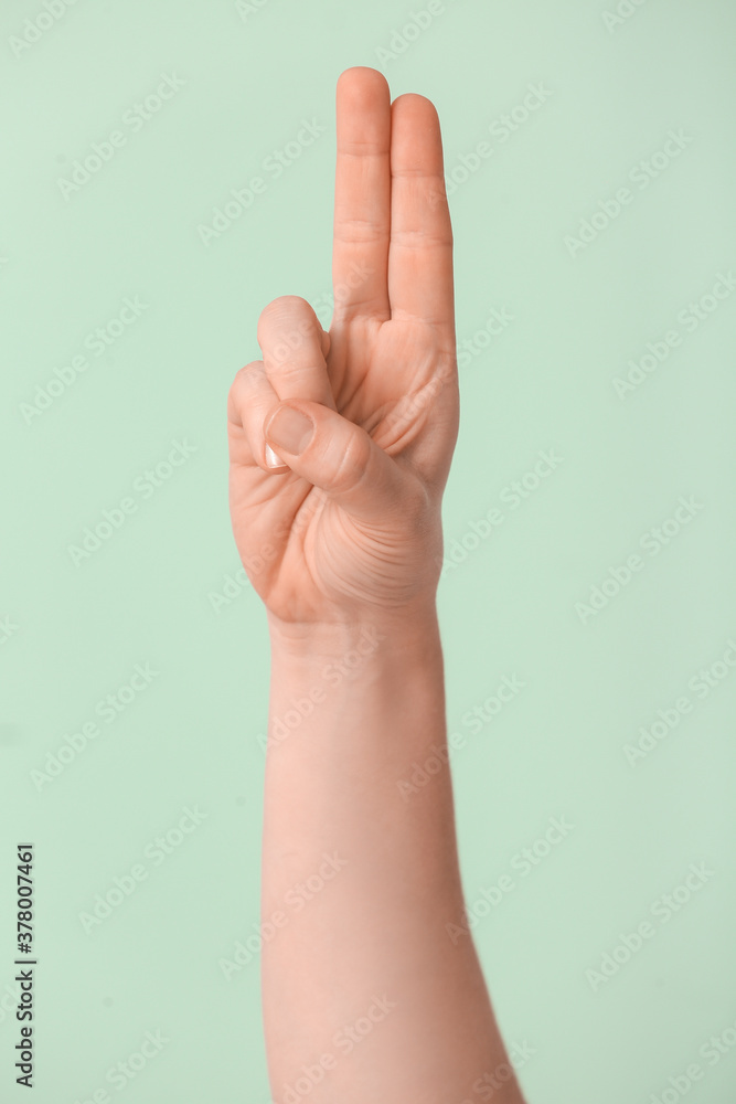Hand showing letter U on color background. Sign language alphabet Hand showing letter U on color background. Sign language alphabet