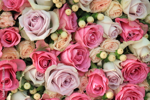 Pink and purple roses in a wedding centerpiece