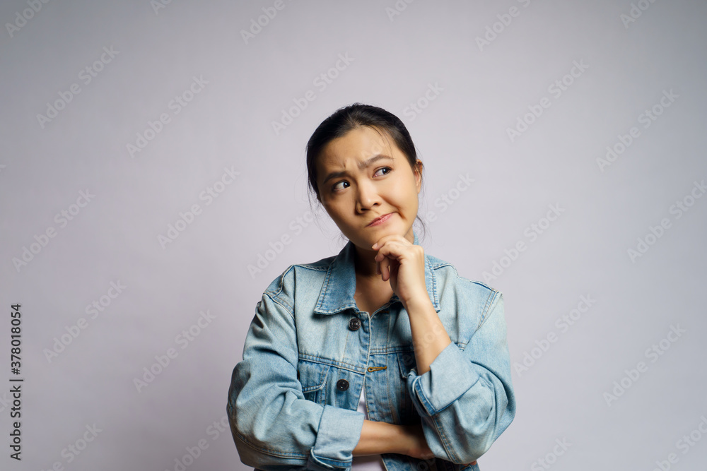 Asian woman thinking about problem, worried and confused emotion isolated over background. Asian woman thinking about problem, worried and confused emotion isolated over background.