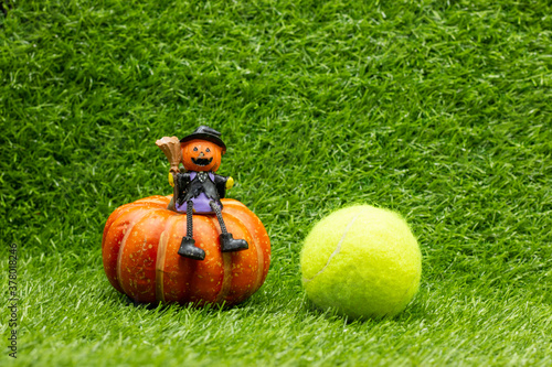 Tennis Halloween with tennis ball on green grass photo