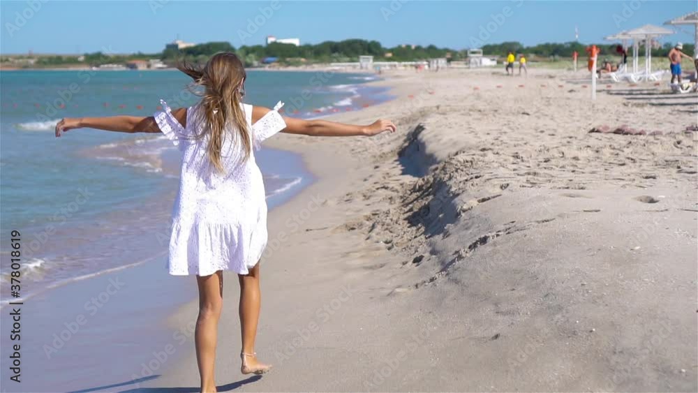 Cute little girl at beach during caribbean vacation Cute little girl at beach during caribbean vacation