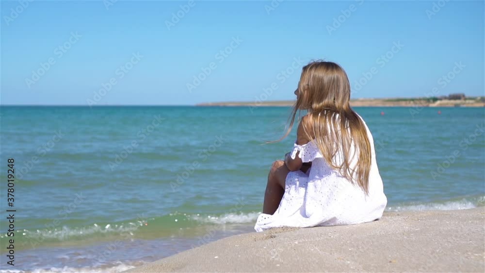Cute little girl at beach during caribbean vacation Cute little girl at beach during caribbean vacation