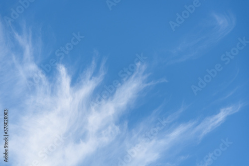 Fresh air  bright blue sky with wispy white clouds  as a nature background 