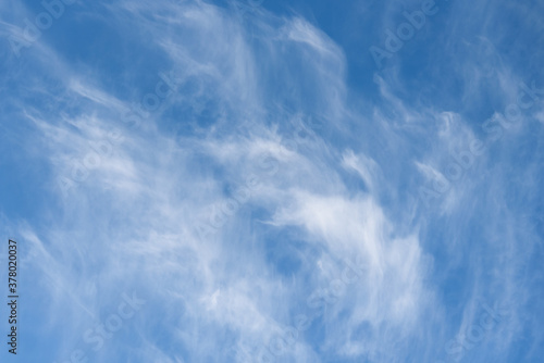 Fresh air, bright blue sky with wispy white clouds, as a nature background 