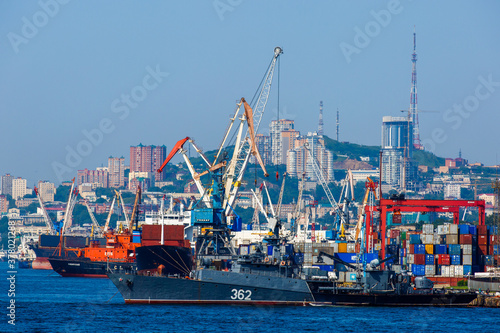 Commercial coasters are loading at the commercial port of Vladivostok.