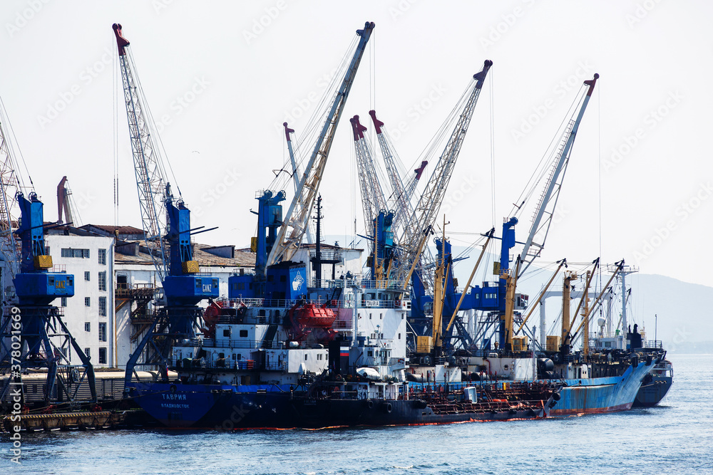 Commercial coasters are loading at the commercial port of Vladivostok.