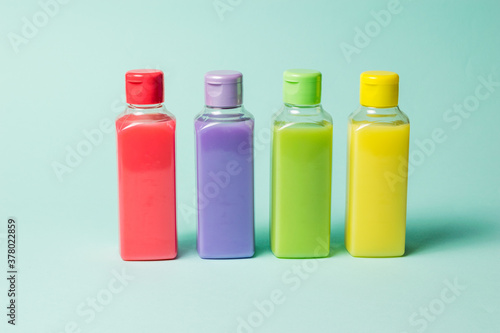 Set of colorful plastic bottles on a light background.