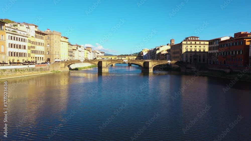 Static aerial view above Arno River and city on a sunny day in Florence in Italy in 4k. Static aerial view above Arno River and city on a sunny day in Florence in Italy in 4k.