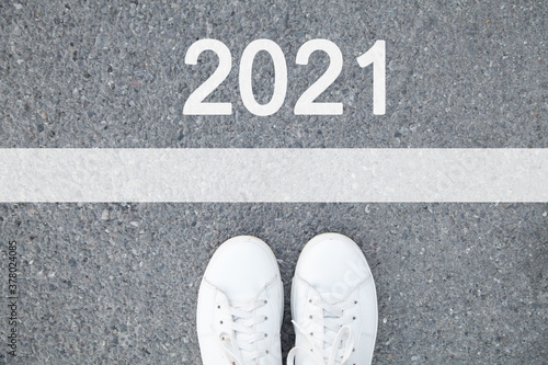 Start 2021. Male shoes on asphalt road