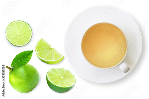 Cup of ginger herbal tea and lime fruit with green leaf isolated on white background. Top view. Flat lay.