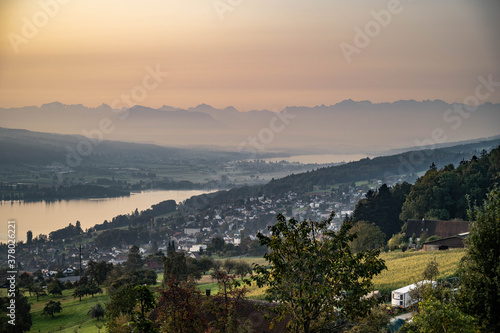 Sunrise over meadows   lakes and the alps