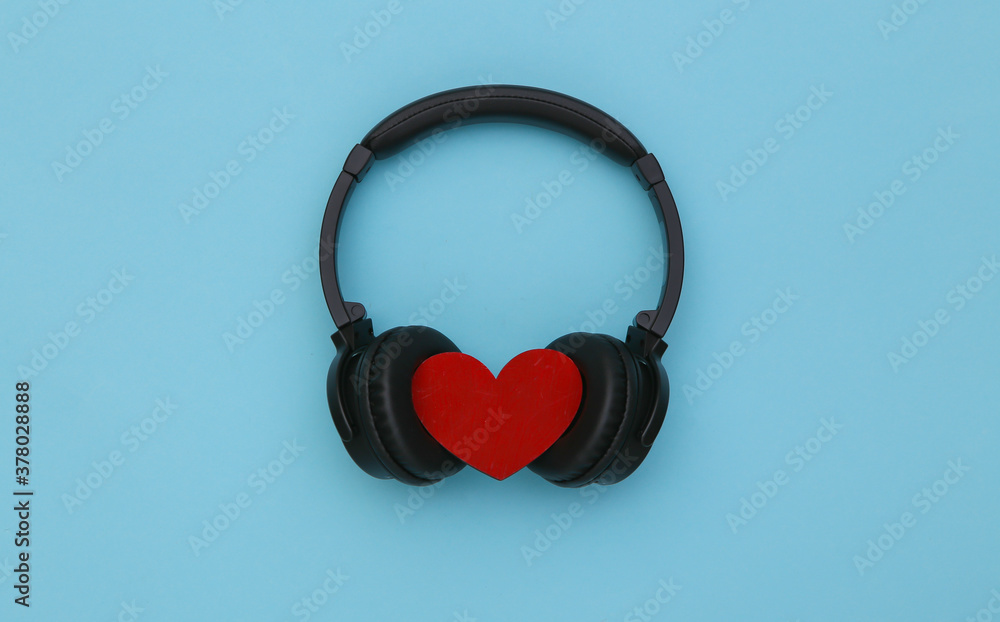 Stereo headphones with heart on a blue background. Music lover