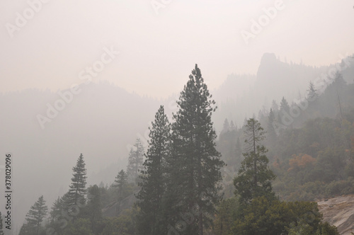 Very hazy and smokey view of mountains and trees from Yosemite Valley, during wildfire season
