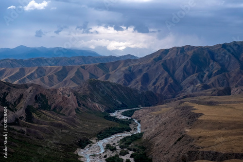 Moutain river valley with sky background. Beautiful wild nature landscape. Adventure travel. Outdoor landscape. Usek river valley in Kazakhstan. Tourism in Kazakhstan concept.