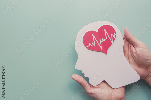 Hands holding paper brain and heart, brain stroke, world heart day, world health day, world mental health day, Alzheimer and wellness concept