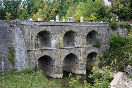 Double bridge surrounded by greenery in Tounj, Croatia photo